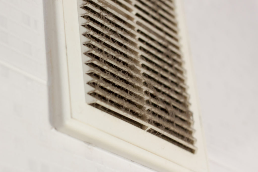 cleaning ventilation plastic dust. the filter is completely clogged with dust and dirt. dirty ventilation in the room. Disinfection service.