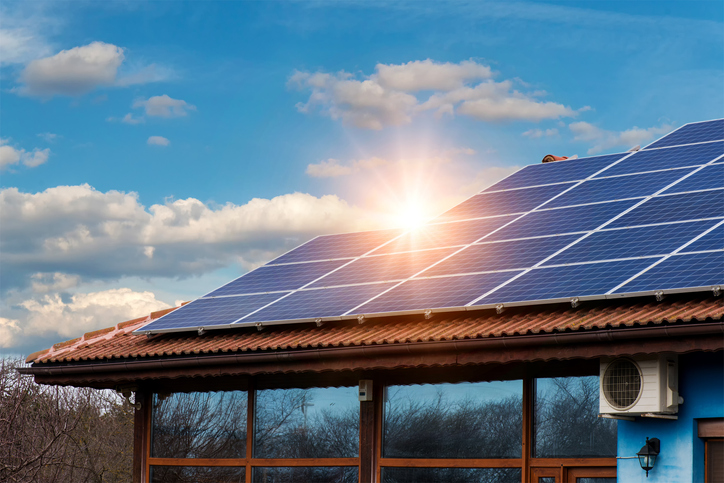 Solar panel on roof with sun coming up